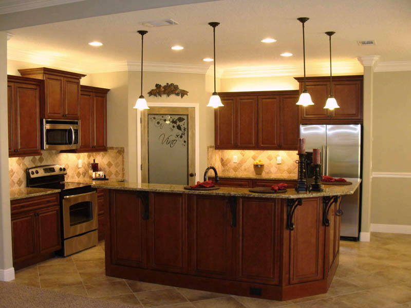 4626 Hermosa Road Crestview, FL 32539 - Photo 8 of 22 a kitchen with kitchen island granite countertop wooden cabinets and stainless steel appliances