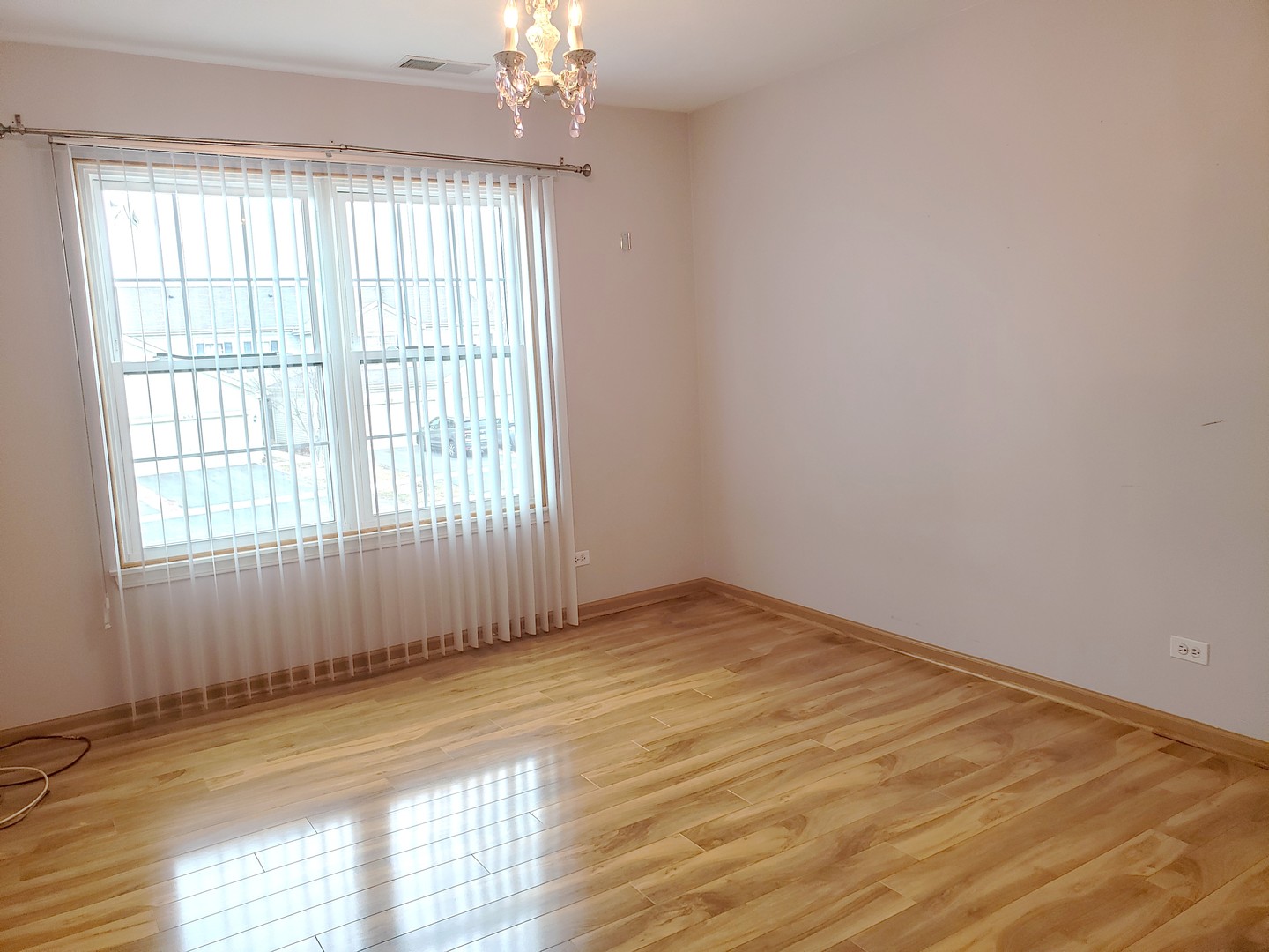 641 West Jonathan Drive Round Lake, IL 60073 - Photo 17 of 20 an empty room with wooden floor and windows