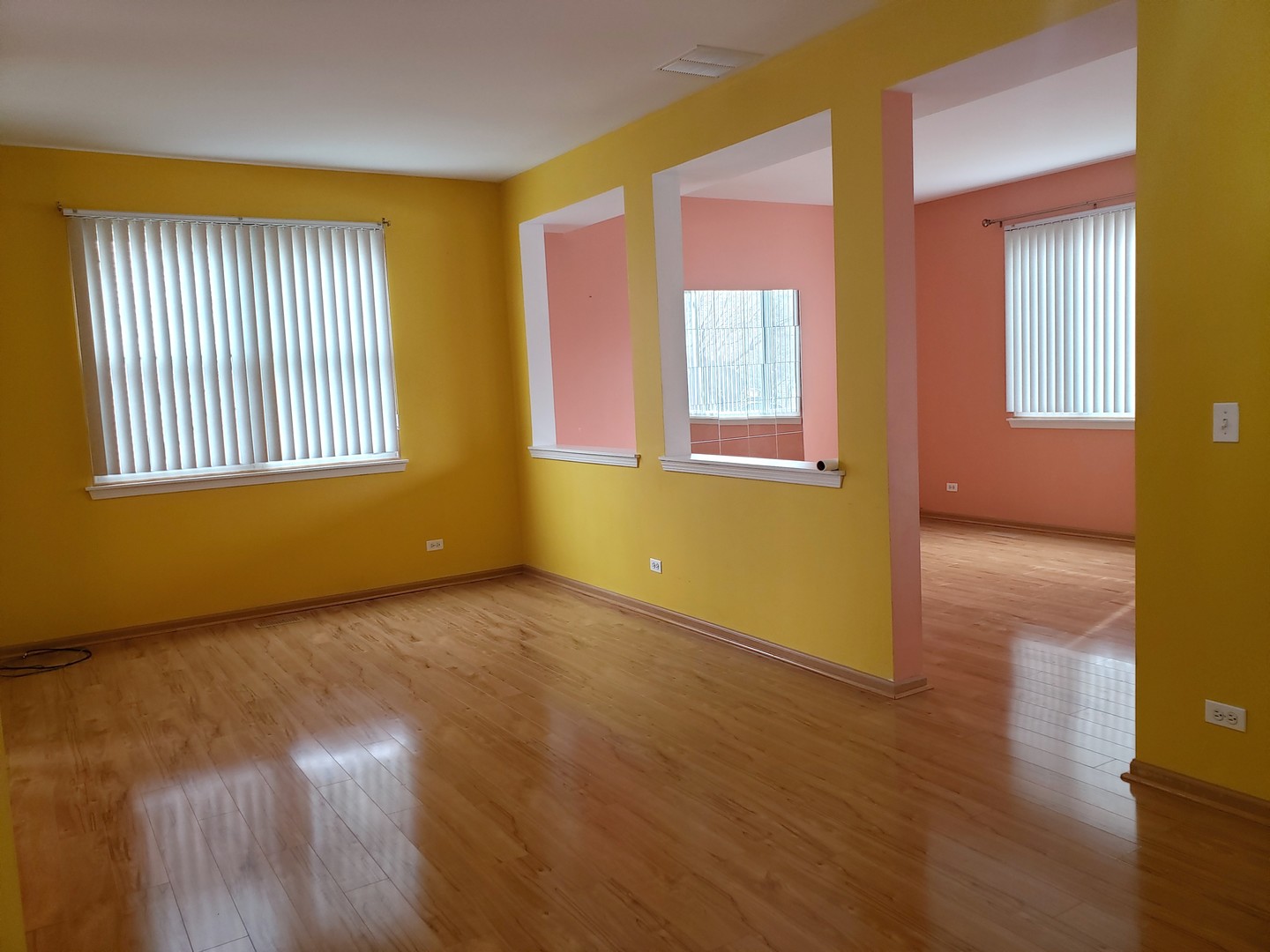 641 West Jonathan Drive Round Lake, IL 60073 - Photo 4 of 20 a view of an empty room with wooden floor and a window
