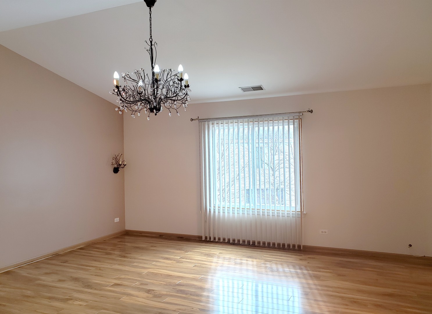 641 West Jonathan Drive Round Lake, IL 60073 - Photo 10 of 20 a view of an empty room with wooden floor and a window