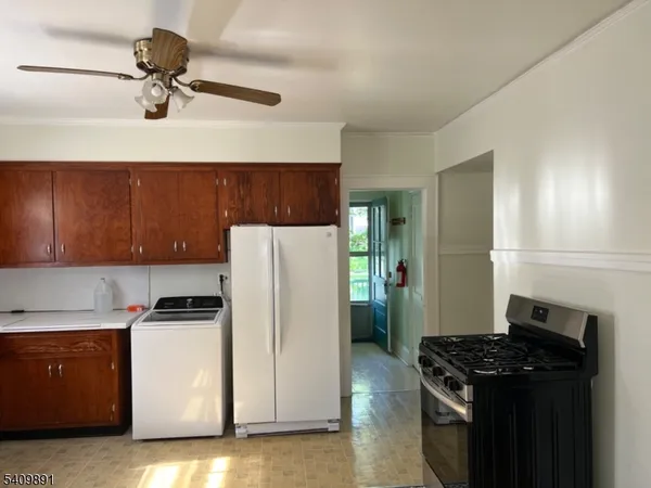 a kitchen with a refrigerator stove and cabinets