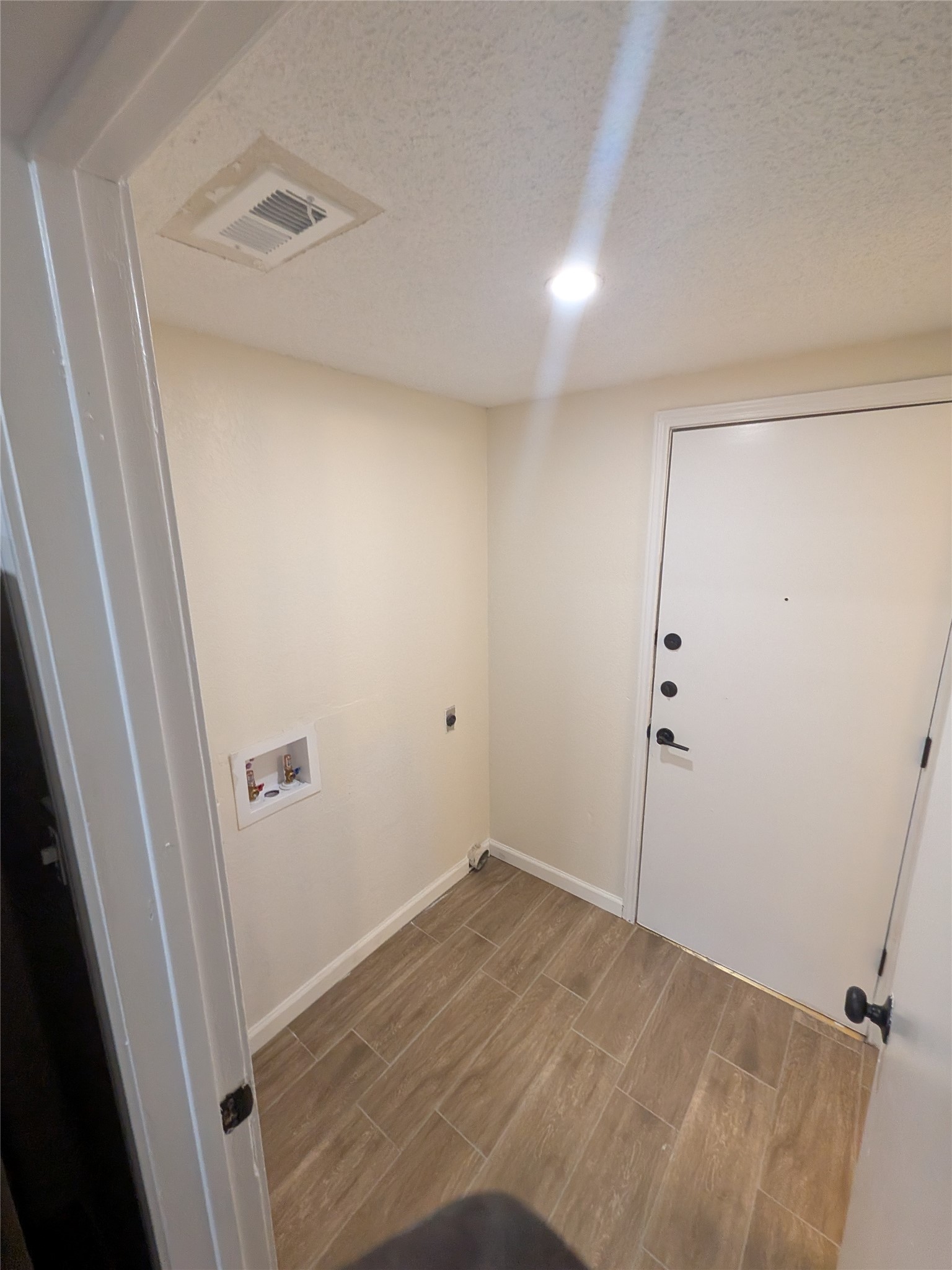 13303 Lyndhurst Street, Unit B Austin, TX 78729 - Photo 7 of 13 A well-lit utility space provides convenient laundry hookups and direct access to the exterior.