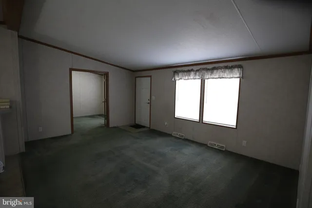 an empty room with a empty space and windows