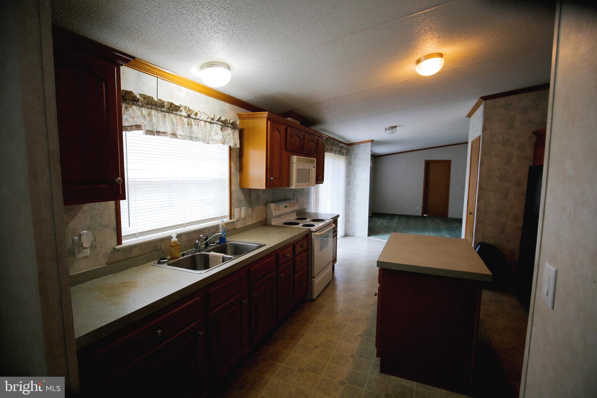 2437 Lebanon Road Manheim, PA 17545 - Photo 6 of 26 a kitchen with stainless steel appliances granite countertop sink stove and refrigerator