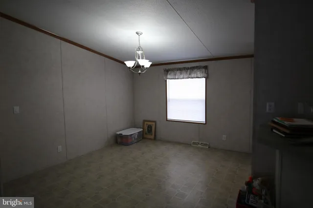 en empty room with windows and fan