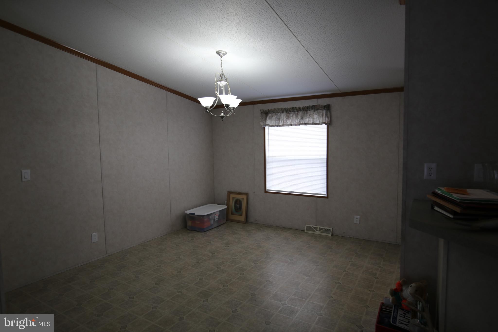 2437 Lebanon Road Manheim, PA 17545 - Photo 7 of 26 en empty room with windows and fan