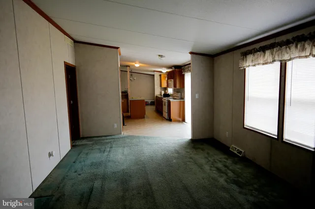 a view of hallway with furniture and a window
