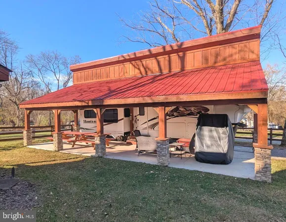 a view of a cafe with a table and chairs under an umbrella