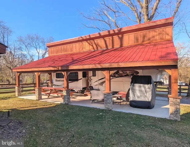a view of a cafe with a table and chairs under an umbrella