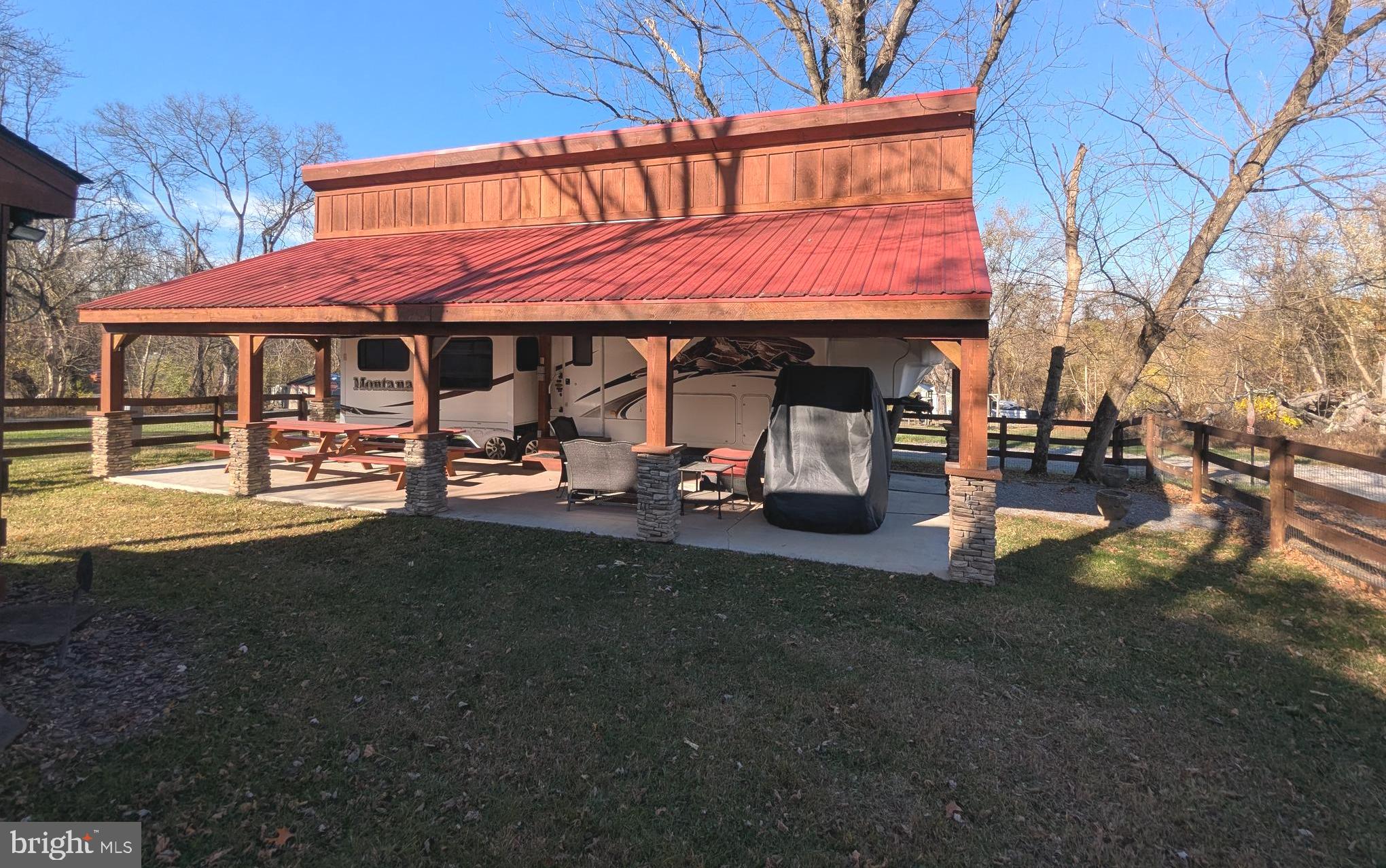 8 Ranger Road Falling Waters, WV 25419 - Photo 3 of 18 a view of a patio with table and chairs under an umbrella