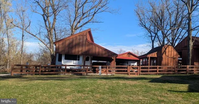 a front view of a house with swimming pool having outdoor seating