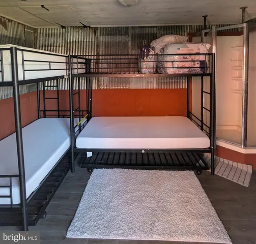 a bedroom with a bed next to a window