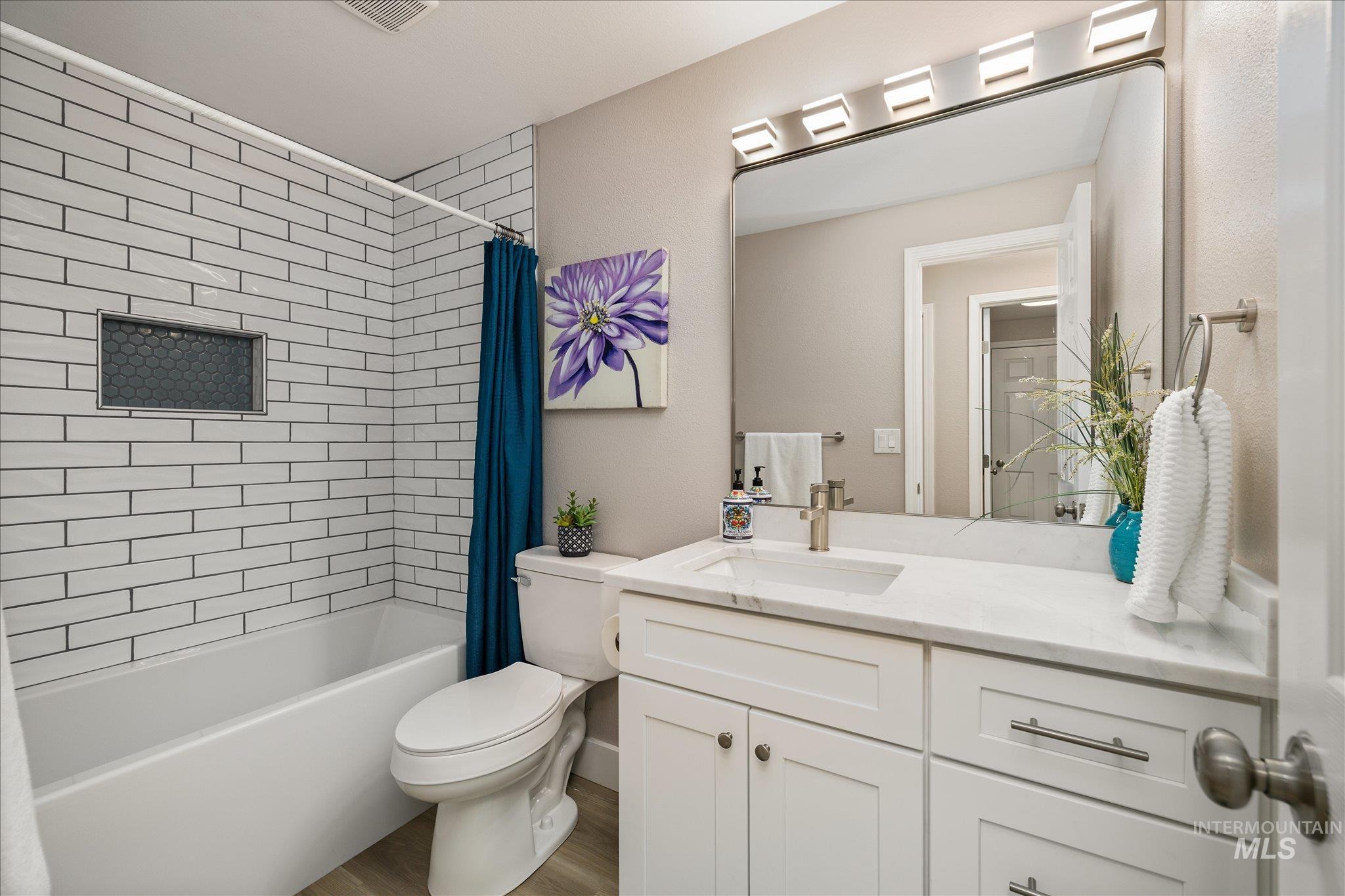 2250 North Amethyst Avenue Meridian, ID 83646 - Photo 40 of 50 Full bath featuring vanity, shower / bath combination with curtain, and wood finished floors