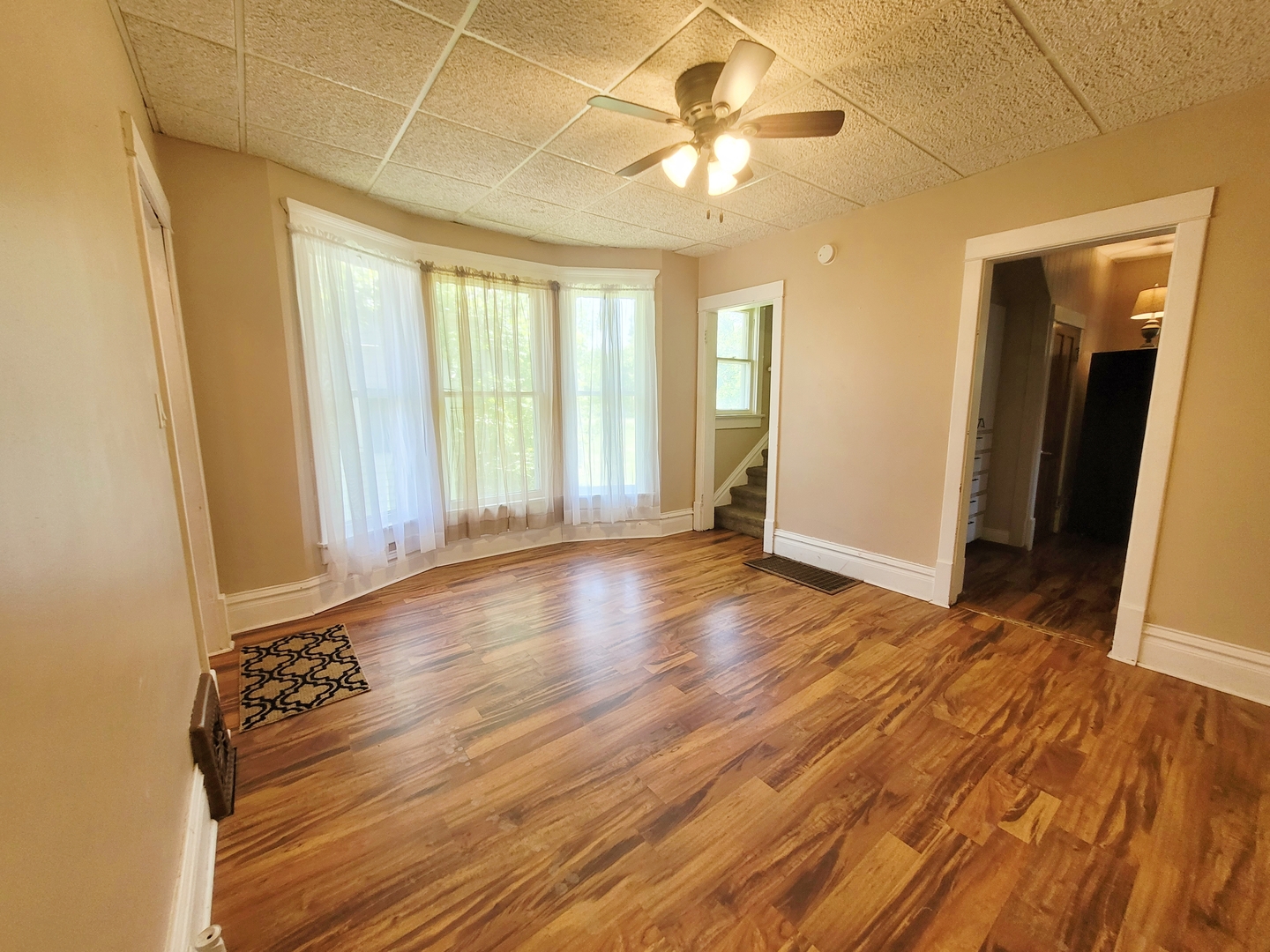 505 East Main Street Morrison, IL 61270 - Photo 5 of 27 an empty room with wooden floor and windows