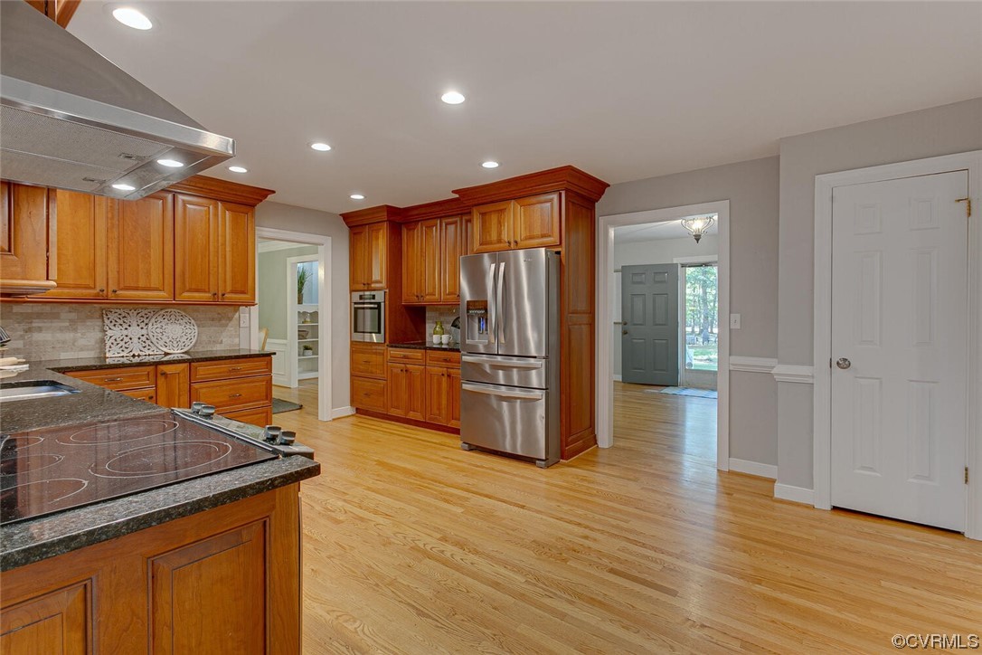 1310 King William Woods Road Midlothian, VA 23113 - Photo 12 of 42 a kitchen with stainless steel appliances granite countertop a refrigerator a stove and a wooden floors