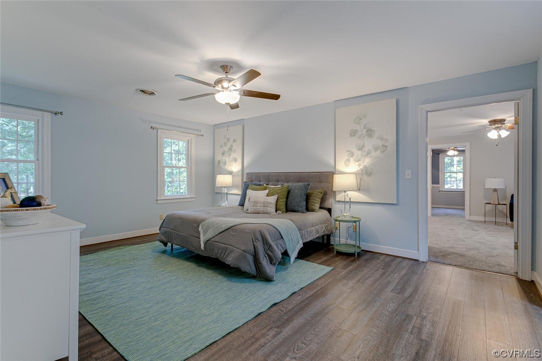 1310 King William Woods Road Midlothian, VA 23113 - Photo 18 of 42 a spacious bedroom with a bed and a chandelier