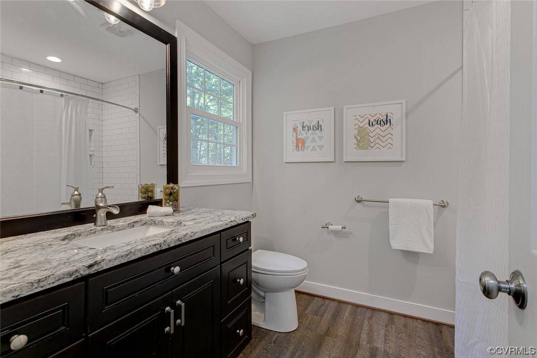 1310 King William Woods Road Midlothian, VA 23113 - Photo 21 of 42 a bathroom with a granite countertop sink toilet and mirror