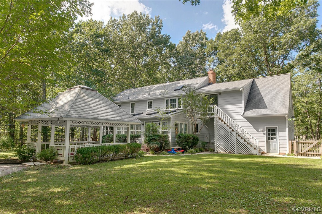 1310 King William Woods Road Midlothian, VA 23113 - Photo 38 of 42 a front view of a house with a garden