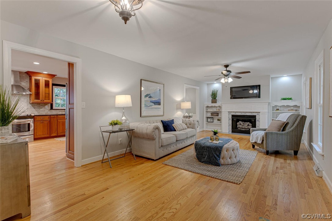 1310 King William Woods Road Midlothian, VA 23113 - Photo 4 of 42 a living room with furniture a fireplace and a flat screen tv