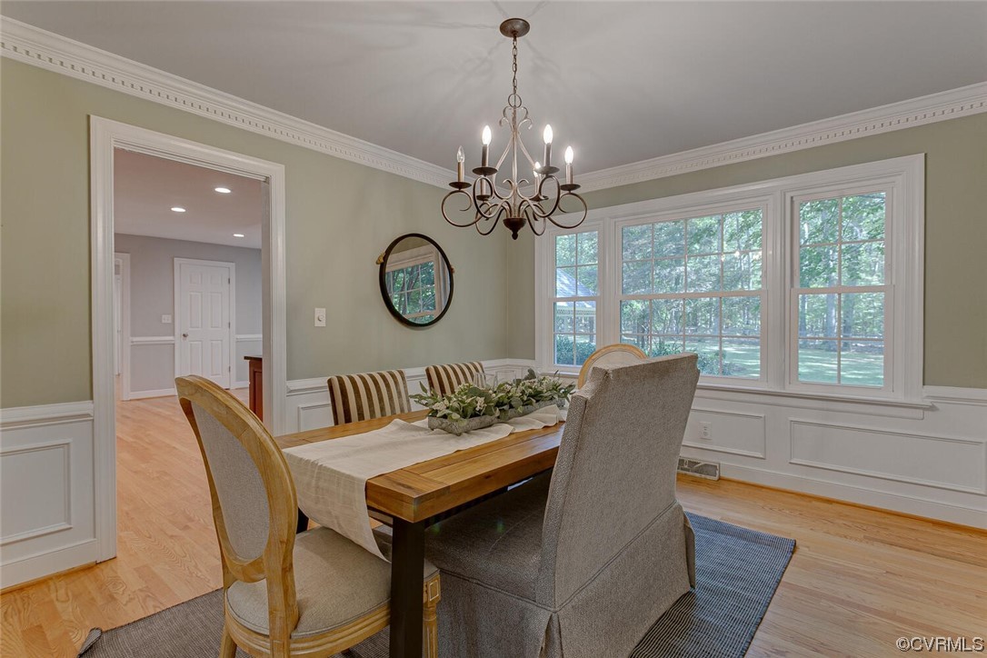 1310 King William Woods Road Midlothian, VA 23113 - Photo 7 of 42 a view of a dining room with furniture a chandelier and wooden floor