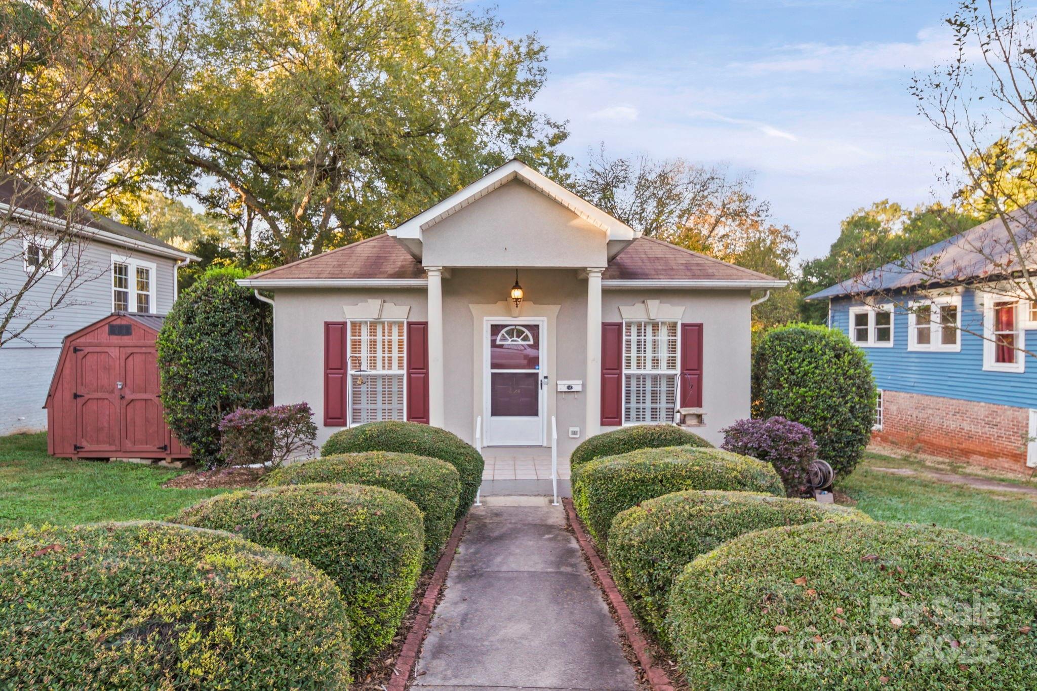 a view of a house with bunch of plants and trees