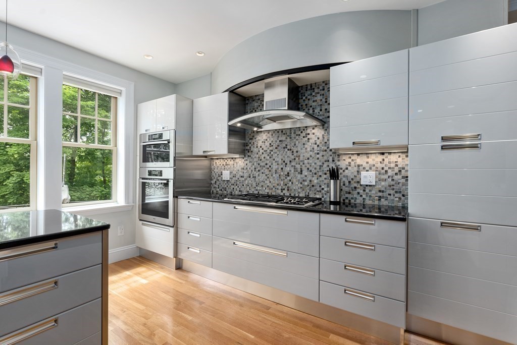 170 Hyslop Road Brookline, MA 02445 - Photo 19 of 37 a kitchen with granite countertop white cabinets and stainless steel appliances