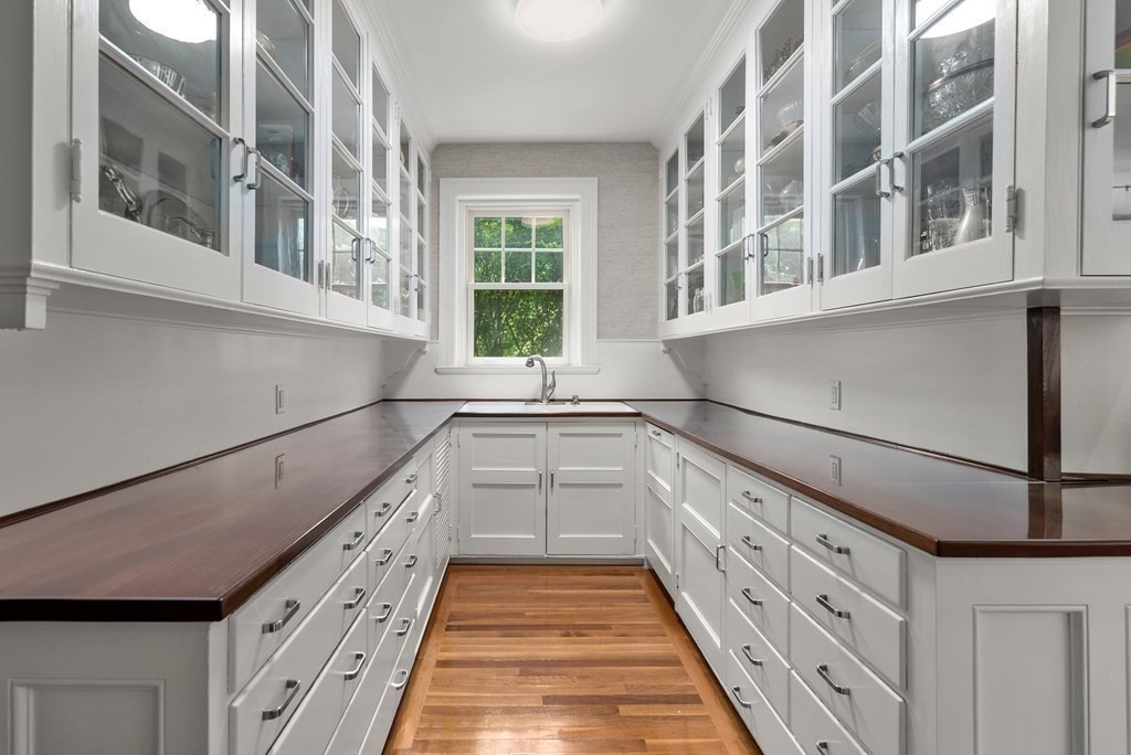 170 Hyslop Road Brookline, MA 02445 - Photo 20 of 37 a kitchen with granite countertop white cabinets and window