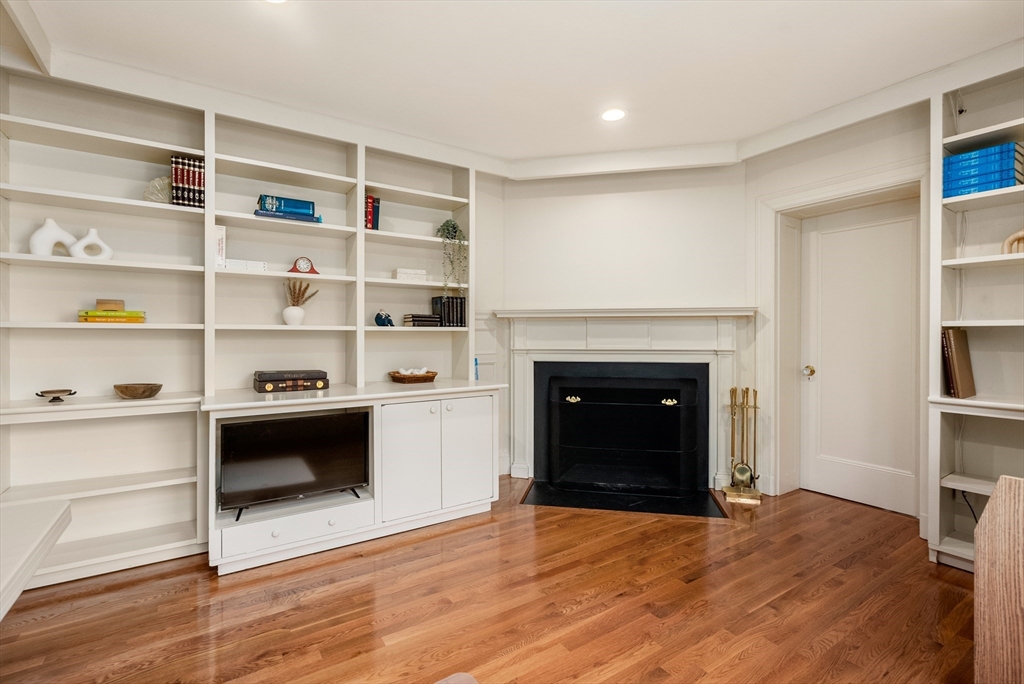 170 Hyslop Road Brookline, MA 02445 - Photo 26 of 37 a room with a fireplace and a book shelf