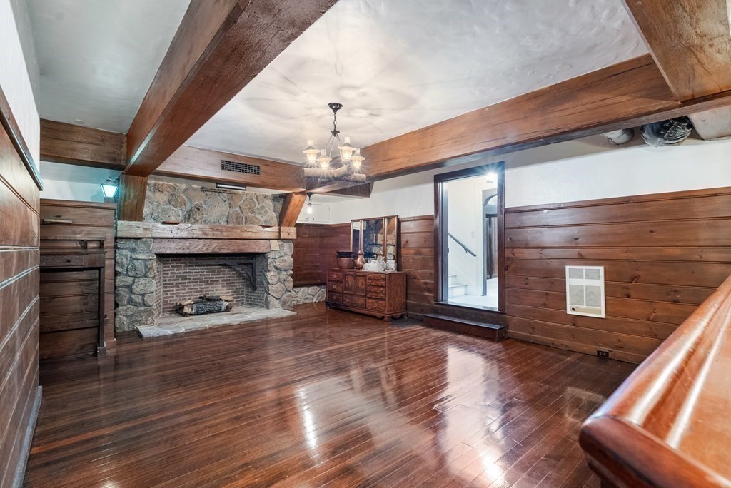 170 Hyslop Road Brookline, MA 02445 - Photo 28 of 37 a view of an empty room with wooden floor fire place and windows