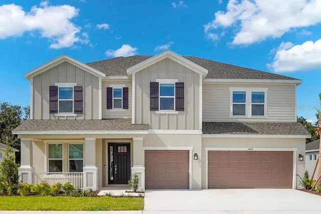 a front view of a house with yard and garage