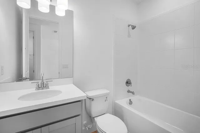 a bathroom with a sink a toilet and bathtub