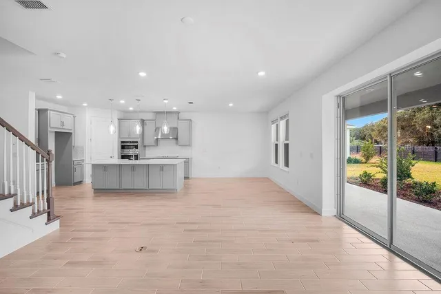 a view of kitchen with kitchen island and stainless steel appliances