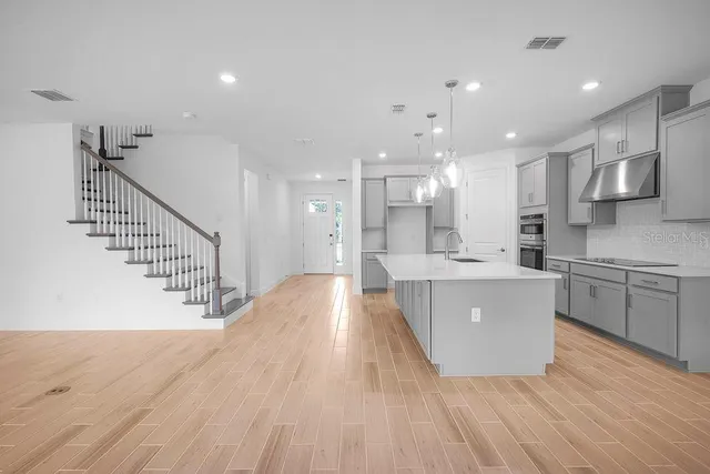 a view of kitchen with cabinets and wooden floor