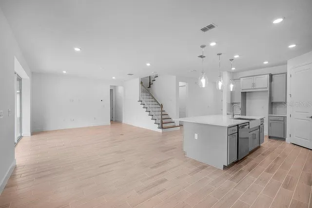 a large kitchen with stainless steel appliances granite countertop a large counter top and a stove