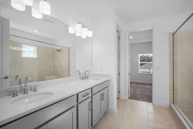 a spacious bathroom with a granite countertop sink a mirror and vanity