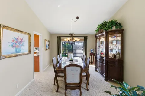 a dining room with furniture window and outside view