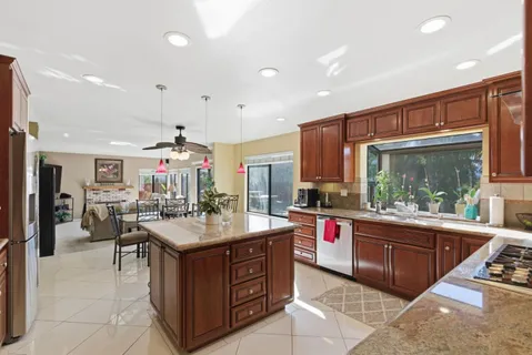 a kitchen with a stove a sink and a refrigerator
