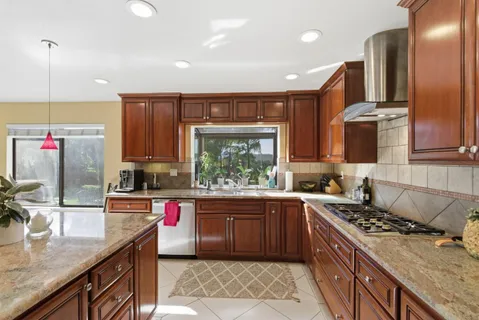 a kitchen with stainless steel appliances a sink stove and cabinets