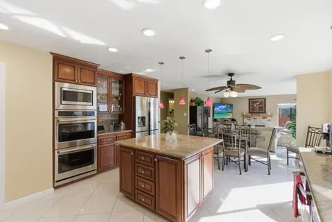 a kitchen with stainless steel appliances granite countertop a stove and a refrigerator