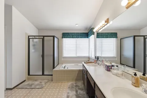 a bathroom with a double vanity sink and a mirror