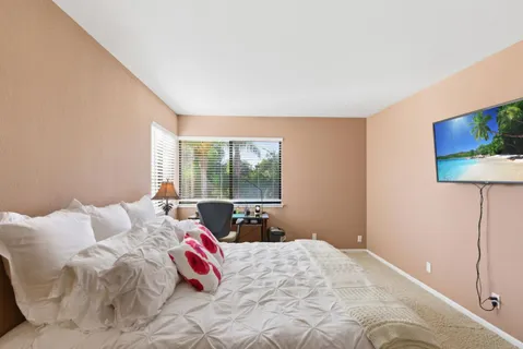 a bedroom with a bed and window
