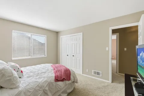 a bedroom with a bed and a window