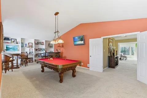 a room with pool table and furniture