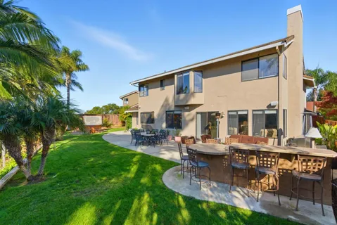 a view of a house with a yard patio and sitting area