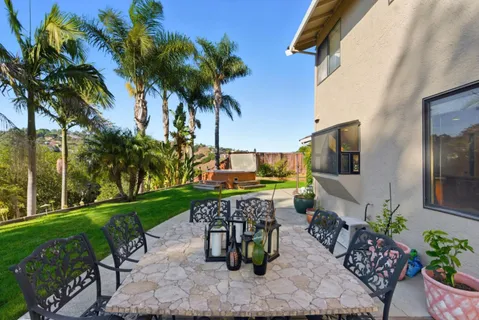a view of a chairs and table in the patio