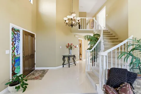 a living room with furniture flowerpot and wooden floor