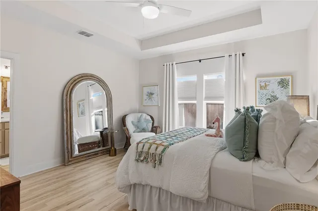 a bedroom with a bed and a large window