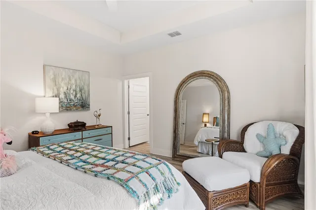 a bedroom with bed and a chair