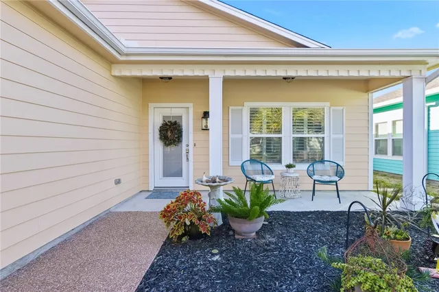 a view of a house with lounge chair and a potted plant