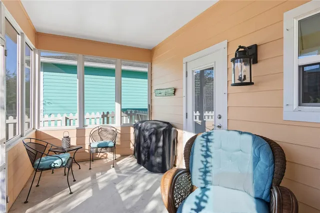 a living room with furniture and large windows